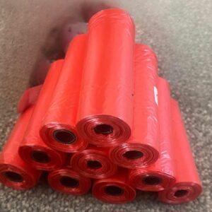 Pack of 10  rolls with  15 strong  poo bags plain red